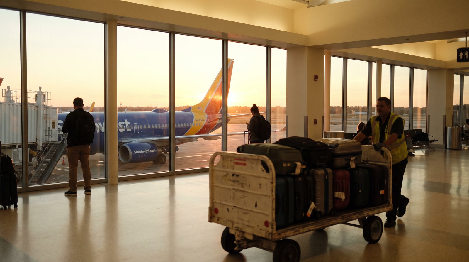 A Southwest Airlines 737 at the gate at sunset.